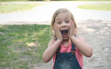 little excited girl making wow gesture. blonde caucasian girl. surprised kid. outdoors activity for children. unbelievable expression.