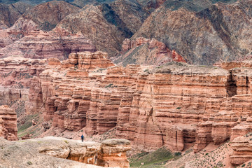 Backpacker on the edge of red sandstone canyon