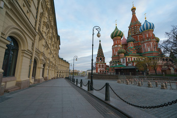 Obraz premium Photography of the domes of the Saint Basil's Cathedral / Cathedral of Vasily the Blessed and facades of GUM (Central Department Store). Moscow Red Square.Coronavirus pandemic time. No people.