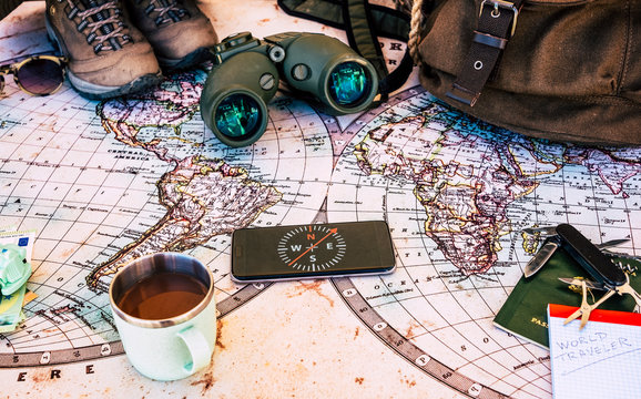 Old map and personal travel accessories such as backpack and cap, money and identity document