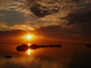 Sunset over the sea. Little island in the Lake. Wonderful view at sunset near the sea.