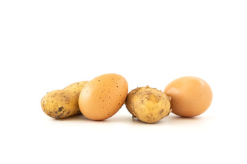 Raw potatoes and eggs isolated on white background
