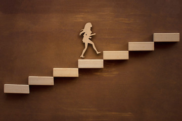 Silhouette enterprising woman climbing the steps of success up