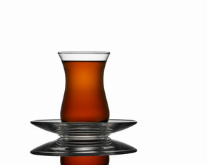 Turkish transparent glass tea cup with tea. Isolated