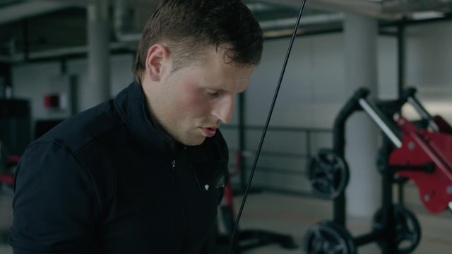 Young mando sport, doing triceps exercise, warming up, in the gym.