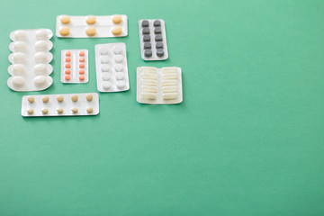 pills in blisters  on green background
