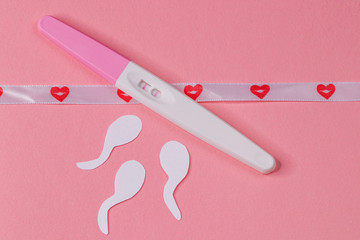 Pregnancy test on pink background