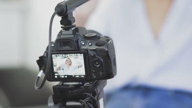 Popular female blogger is turning on the camera and strating recording video