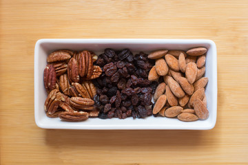 Top view of a container with raisins, nuts and almonds