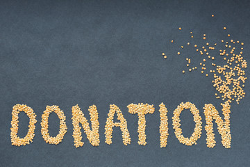 the word donate made from cereals on a black background