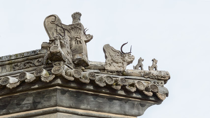  Richly decorated roofs of Chinese houses, small carved figures on the roof. © Castigatio