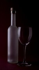 Wine glasses on black backround and wine bottles