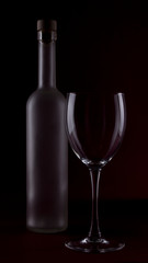 Wine glasses on black backround and wine bottles