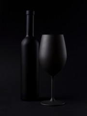 Wine glasses on black backround and wine bottles