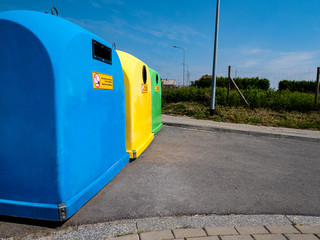 Garbage recycling concept, colorful plastic garbage containers on the street of the city with place for text.