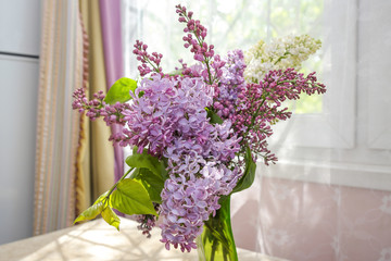 lilac bouquet on the table in the sunny room