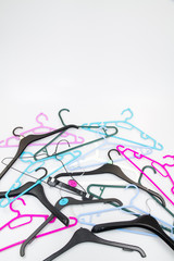 Mixed plastic and metal coat hangers in different colours.