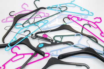 Mixed plastic and metal coat hangers in different colours.