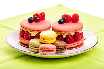 italian Raspberry macaron. Brownies with raspberries and cream,   and multi-colored macarons on a plate 