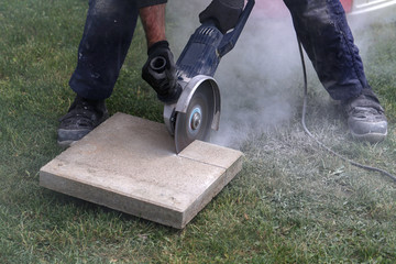 Industrial construction worker using a professional angle grinder