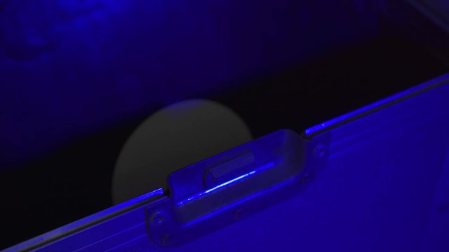 A Dj opening a Record box flight case and taking out a record