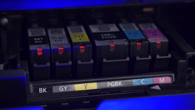A printerhead moving to expose the toner ink cartridges