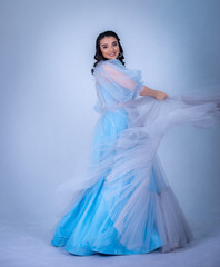 young beautiful model in the image of princesse ,cinderella dressed in a blue dress