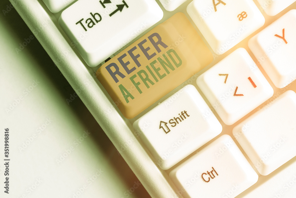 Aufkleber writing note showing refer a friend. business concept for direct someone to another or send him some
