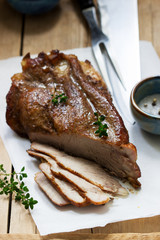 Baked pork shoulder on the bone with spices, herbs and aromatic oil.