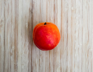Ripe apricots against a wooden background.