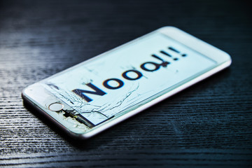 Image of smartphone with broken screen and the word Nooo!!! on it