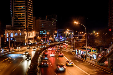Beijing at night, driving cars on a busy road in the city.