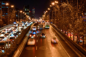 Beijing at night, driving cars on a busy road in the city.