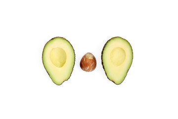 Two halves of avocado with a bone or pit, isolated on a white background.