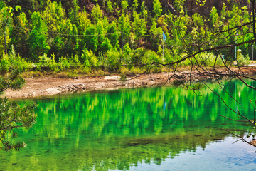 Azure lake. The concept of landscape and relaxing in the fresh air. Trukus water reservoir, attraction and a beautiful place to spend free time. Beautiful forest and water landscape.