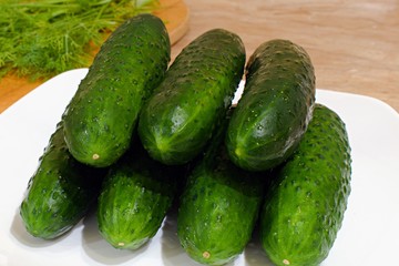 green cucumbers on a white plate