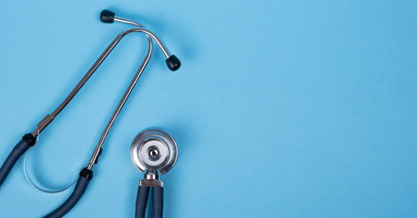 Stethoscope on a light blue background. Health care and surgical concept.