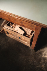 Detail in top view of a drawer of a work table full of scraps of wood in a carpentry