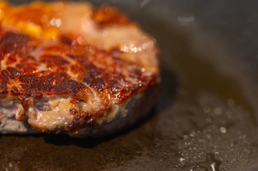 Pictures of a sliced fresh rump  steak with fat on the steak in a pan, which the steak cooks through in high heat
