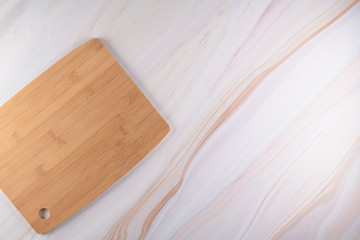 Wooden cutting board on a gray marble background