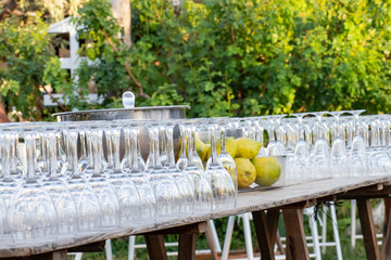 Upside-down crystal glasses on a rustic table for drinks at an event on a rural estate