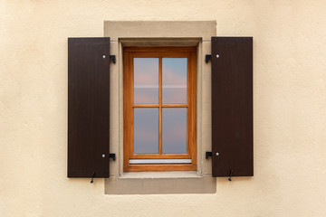 Vintage windows with wooden shutters and fresh flowers