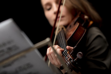 Woman playing a classical violin during a recital
