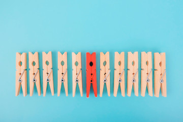 Red wooden clothespin - difference in crowd, leadership, difference in concept. personality stands...