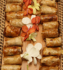 spring rolls and flower petals in basket
