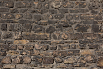Ancient brick stone wall. Antique brown brick wall. Texture and background