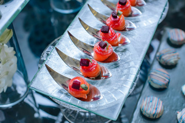 
Salmon catering wrapped in a tube, decorated with a cube of beets and a green leaf