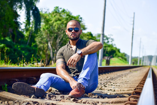 Man with styled on the train tracks