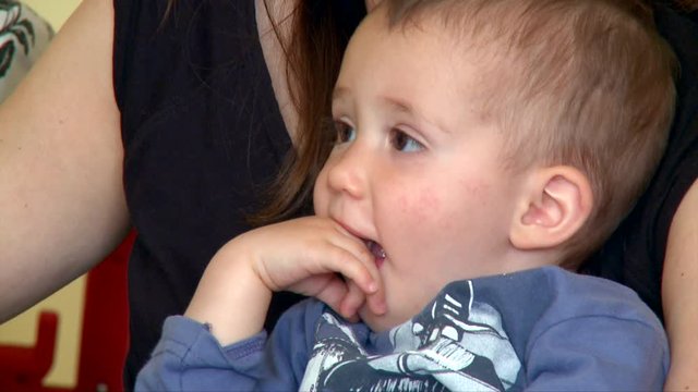 Distracted Baby Smiles while Watches Something on his Mommy Hips, Super Cuteness Level 100, Interior Room, 4K