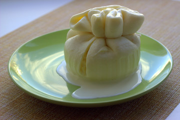 
Cheese flat lay - strachatella, with an incision from which cream flows